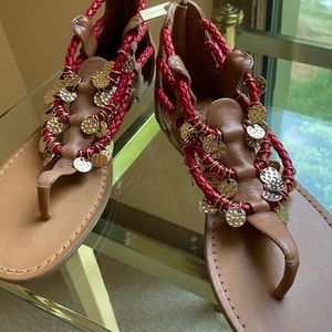 Sandals with red rope trim and gold charm accents
